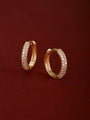 Matching pair of KOSINER Essentials gold-plated 925 sterling silver mini clicker hoops fully encrusted with double row pavé round crystals, inner band stamped 925, shot on soft burgundy suede fabric background