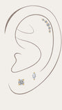 14K solid gold delicate lab-grown diamond ear piercing set styled on simple ear outline, featuring curved arc cartilage stud, round solitaire labret stud, marquise cut diamond flat back piercing, minimalist fine jewelry ear curation stack