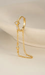 KOSINER Rising Star gold-plated star chain hoop worn in the first lobe piercing with celestial studs and an ear cuff