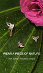 KOSINER Gem Garden nature-inspired colorful gem piercing studs laid on dewy green leaves and magenta rose, featuring triangle three-tone, teardrop dangle, mixed marquise-pear multi-shape flat back styles
