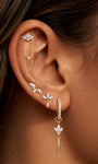 Close-up of KOSINER blooming lotus flat back stud styled in a curated ear stack