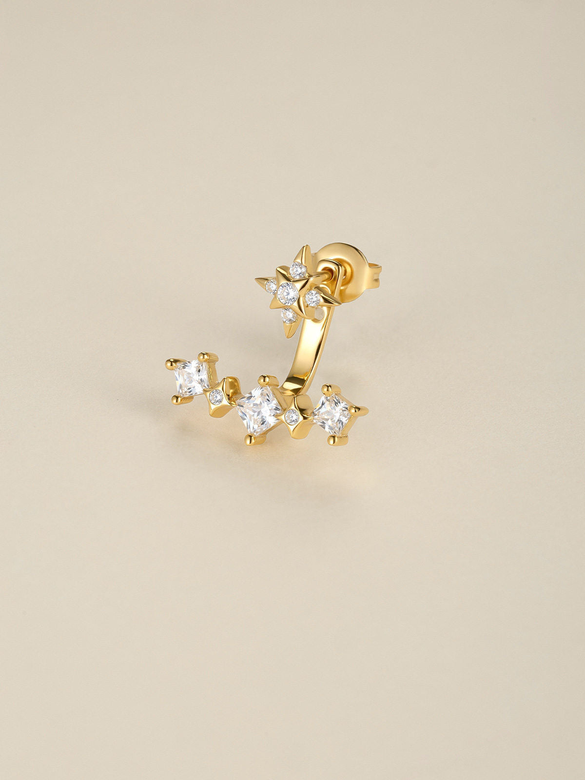 KOSINER Rising Star gold-plated curved earring worn on the lobe, with three clear stones below the ear