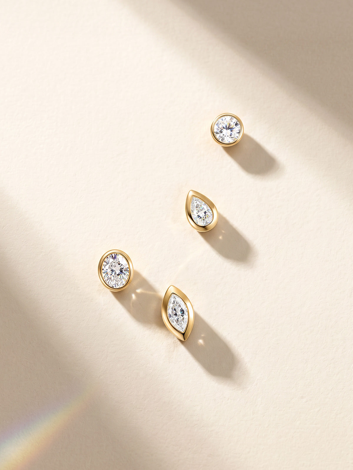 KOSINER 14K solid gold bezel-set lab-grown diamond studs in round, oval, pear and marquise shapes
