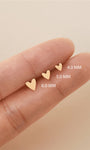 KOSINER 14K solid gold heart stud worn solo or layered in curated ear stack