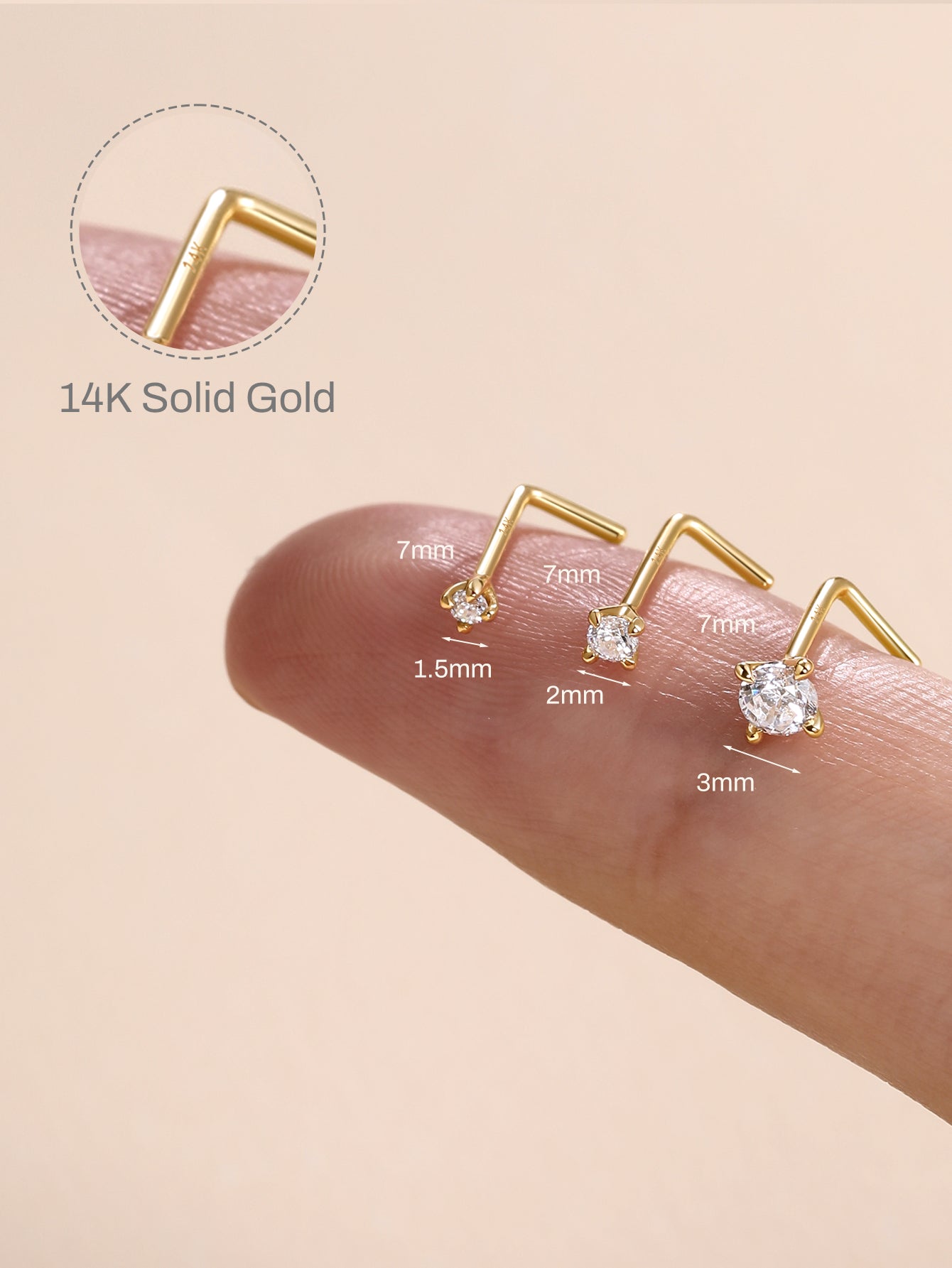 KOSINER L-shape nose studs in 1.5mm, 2mm, 3mm stone sizes laid across fingertip with dimension labels, inset close-up showing engraved 14K solid gold marking
