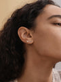 KOSINER cocktail glass stud paired with other ocean-themed piercings