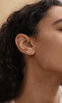 KOSINER cocktail glass stud paired with other ocean-themed piercings