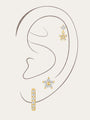 Gold sterling silver earrings with flower, butterfly, and hoop designs with zircon stones, worn on ear for styling.