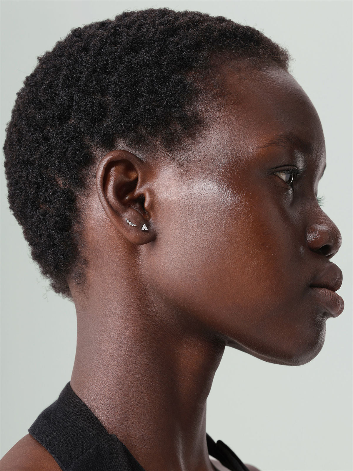 Curved five-stone cartilage stud, minimalist design for curated ear stack, 14K yellow gold