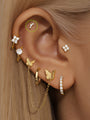 14K solid gold curved piercing stud with three pave lab diamonds, shown on ear.