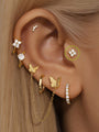 14K solid gold four flower piercing stud with clear cubic zirconia, flatback labret design on ear.