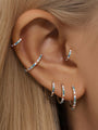 Silver titanium 16g cartilage hoop earrings and cuff with colorful 5A CZ stones on ear, multiple sizes.
