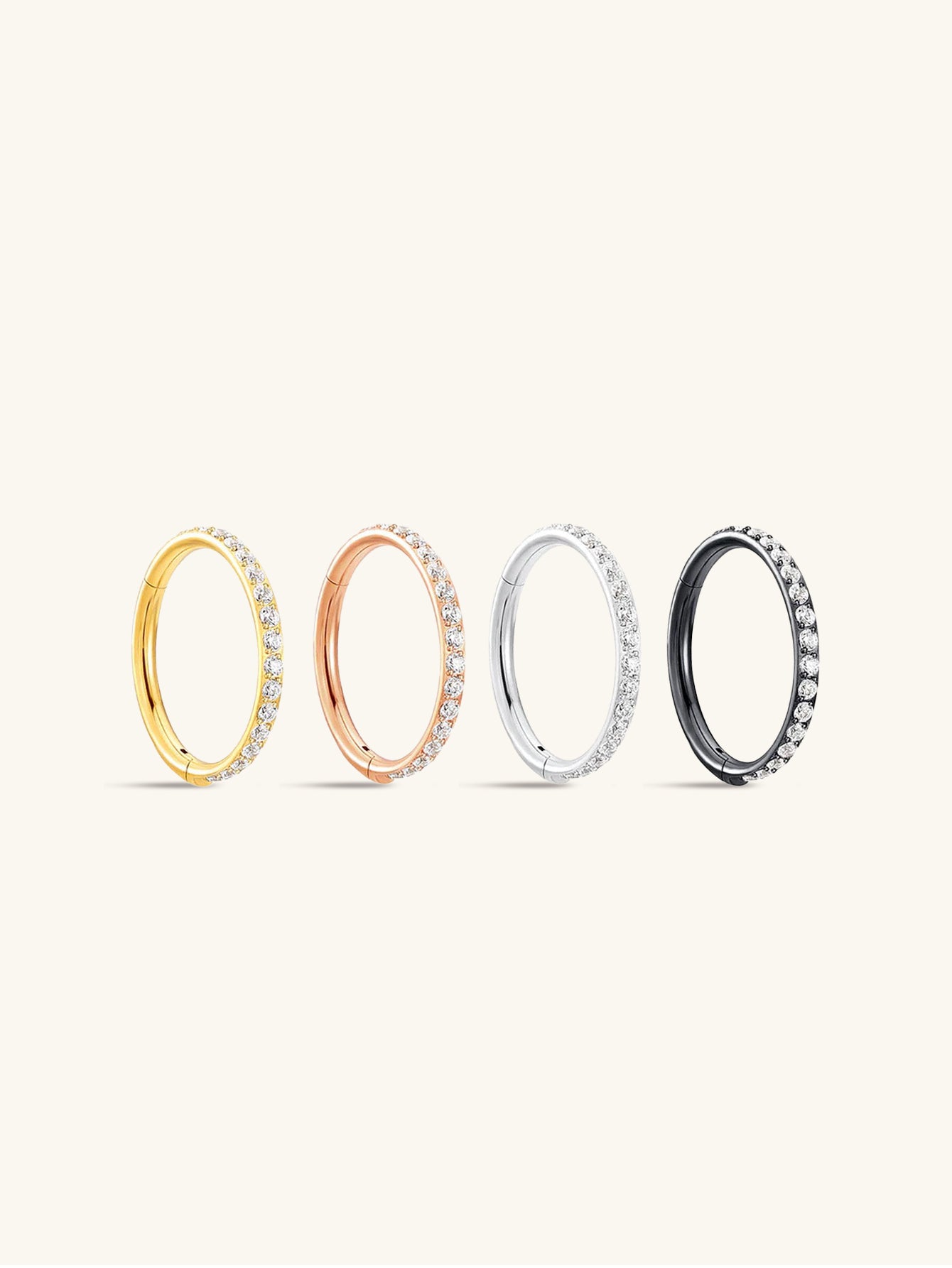 Four titanium 16g cartilage hoop earrings with CZ stones in gold, rose gold, silver, and black.