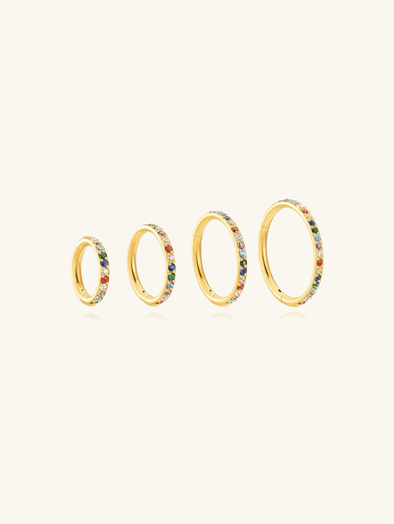 Four gold titanium cartilage hoop earrings with colorful cubic zirconia stones, showcasing different sizes from 6mm to 12mm.