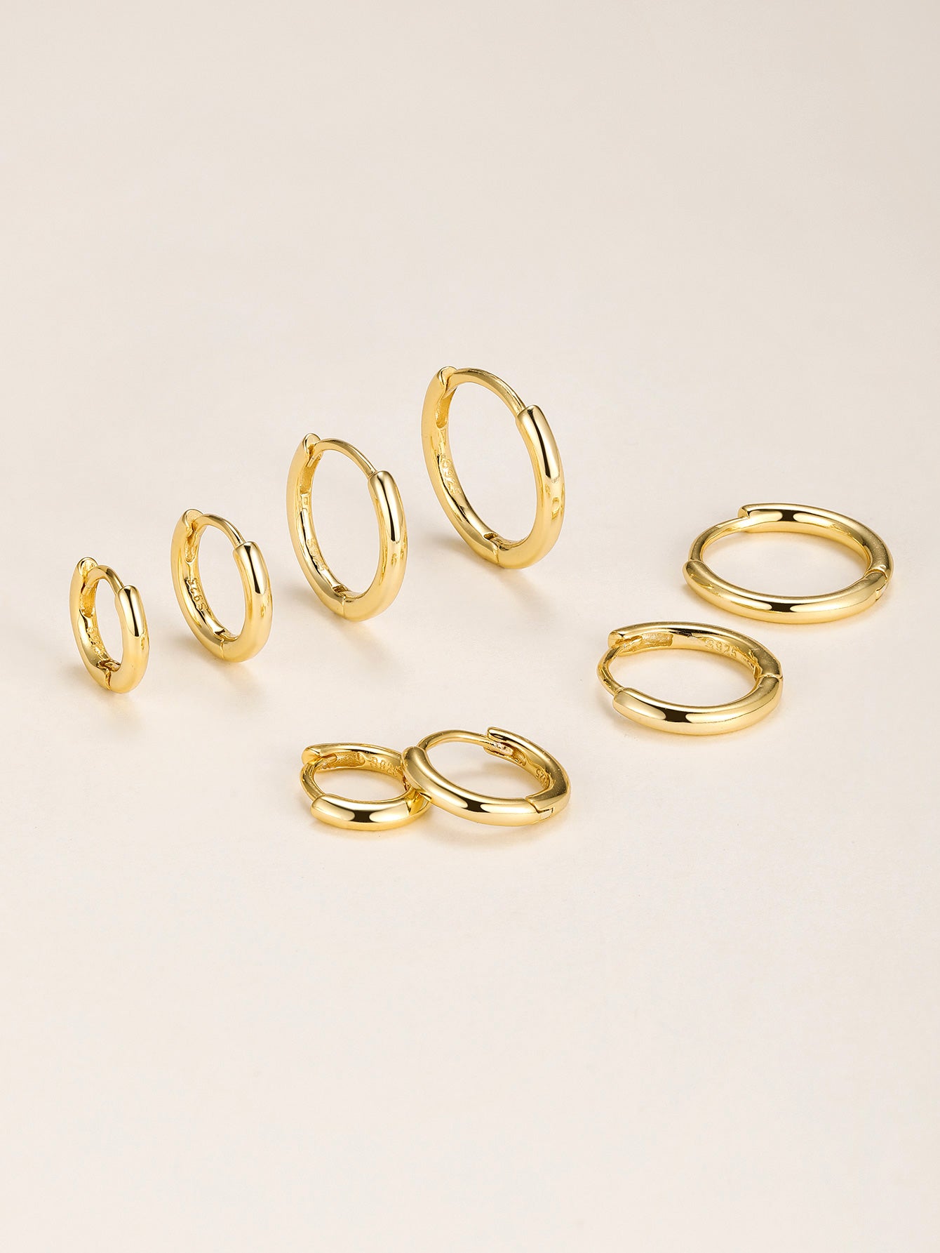 Assortment of 18K gold-plated 925 sterling silver hoop earrings in multiple sizes, perfect for daily casual wear.