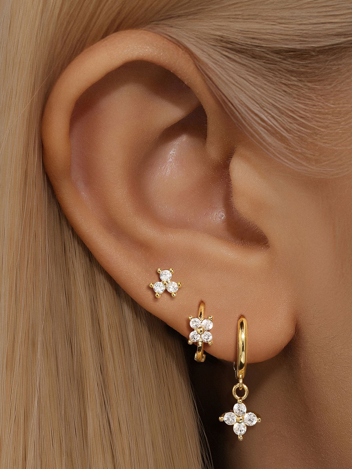 Gold plated sterling silver earrings: stud, floral hoop, and floral dangle with cubic zirconia stones.