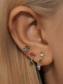 925 Sterling Silver gold plated irregular earrings set with colorful blue, pink, green cubic zirconia stones shown on ear.
