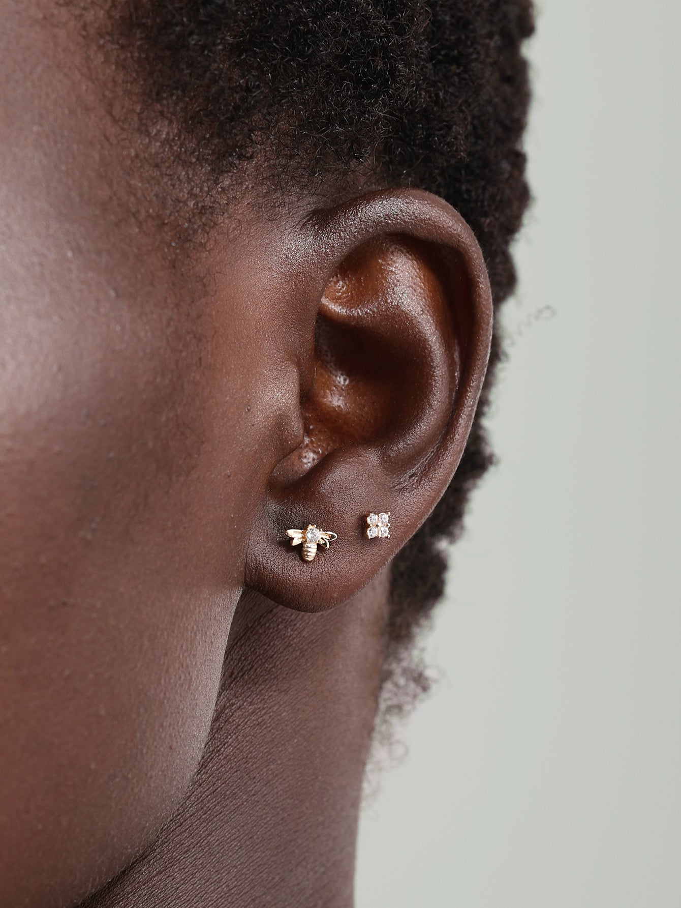 14K solid gold four flower ear piercing stud with cubic zirconia on ear.