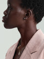 Model wearing 14K gold classic round ear piercing stud with clear cubic zirconia and gold necklace on model.