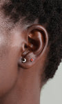 14K gold moon stud piercing with diamonds on earlobe, shown with flat back closure.