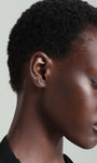 14K gold leaf stud earring with cubic zirconia on ear, internally threaded flatback.