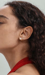 14K solid gold stud earring with pearl and tiny cubic zirconia, shown on a woman's ear. Internally threaded labret.
