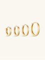Four glossy solid 14K gold hoop earrings in various sizes, product view.