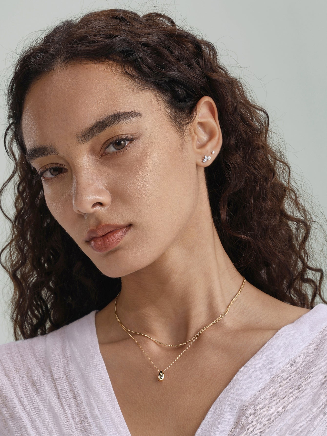 14K solid gold crown piercing stud with marquise CZ on model's ear.