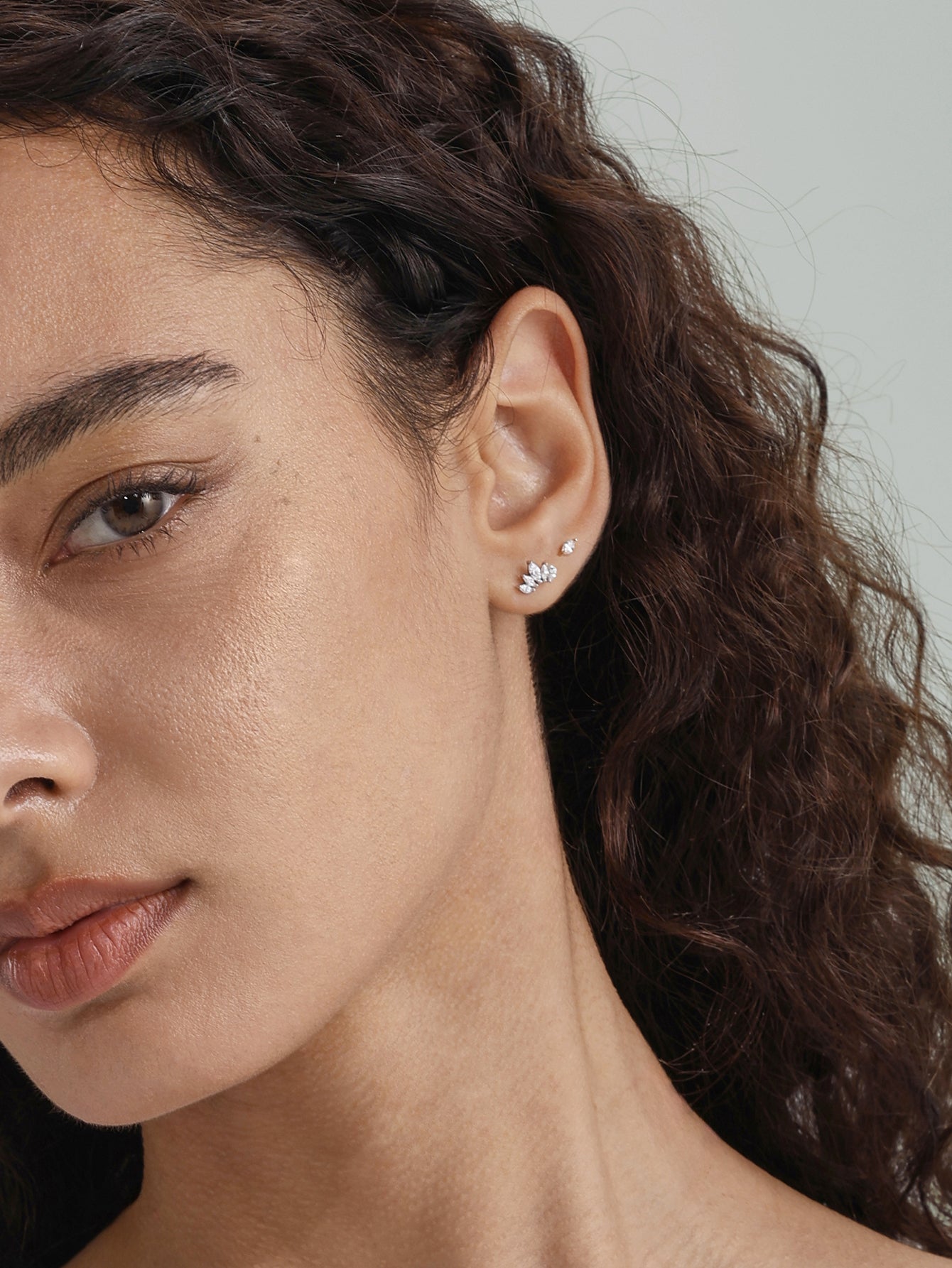 14K solid gold leaf threaded ear piercing stud with marquise CZ, styled on earlobe with a single stone stud.