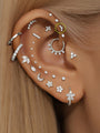 14K solid gold pave curved ear piercing stud on ear, styled with other gold piercings.