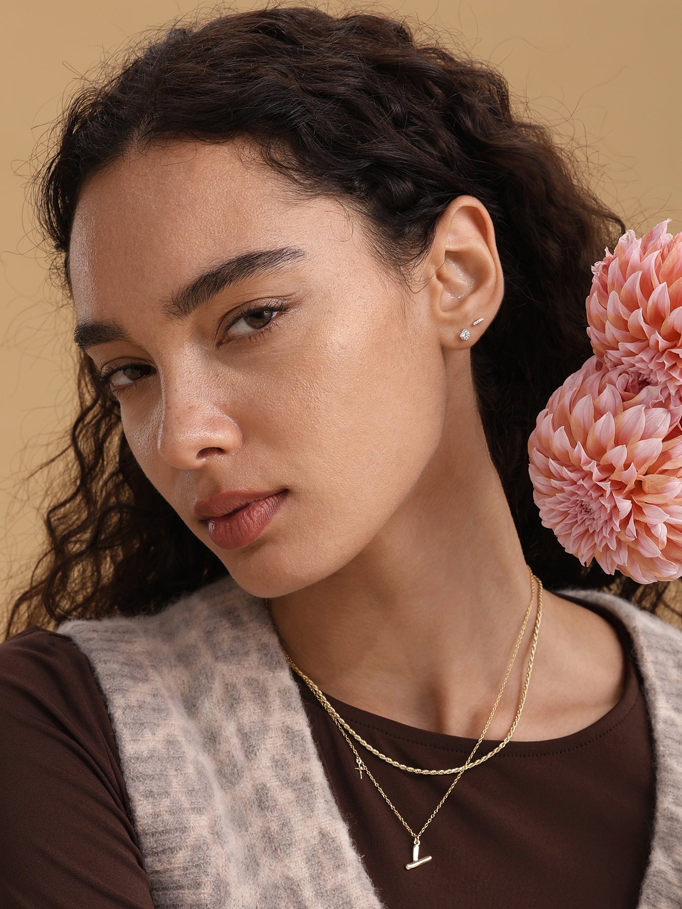 Model showcasing 14K solid gold bar piercing stud with single cubic zirconia, internally threaded labret, 18G.