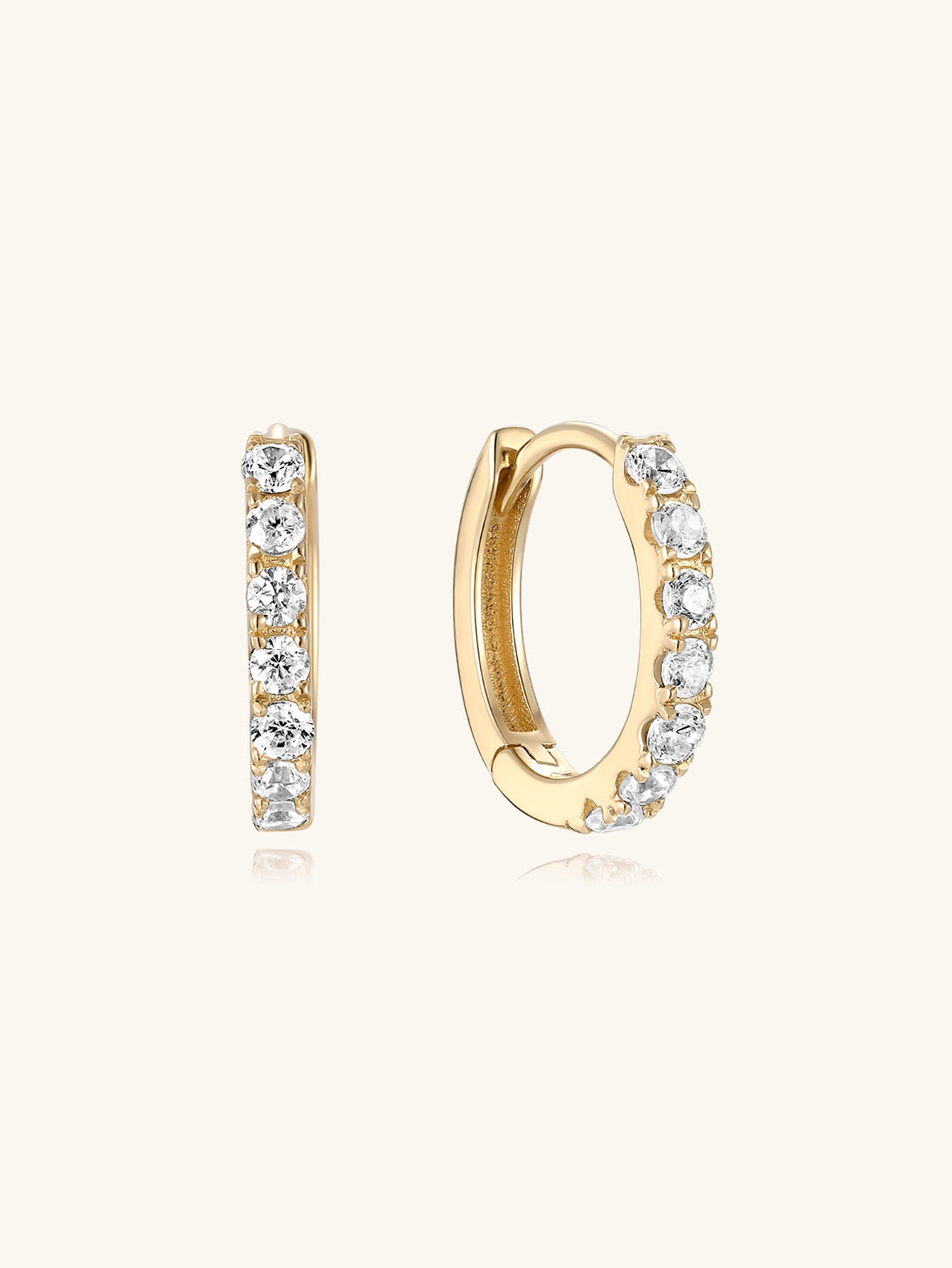 14K solid gold shiny zircon hoop earrings showcasing sparkling cubic zirconia crystals on a neutral background.
