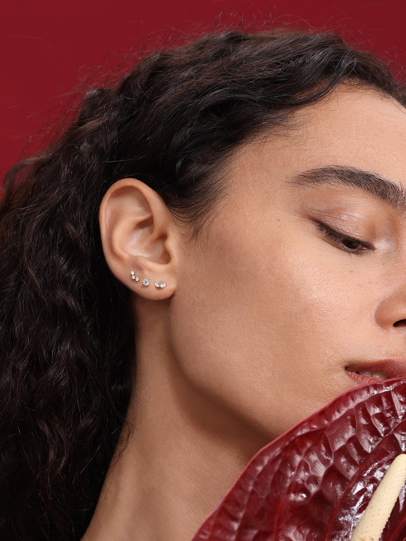 14K solid gold mini simple zircon flatback stud earring on a model's ear, showcasing scale and style.