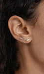 14K gold bar piercing stud with three small cubic zirconia stones on ear helix.
