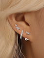 Curated ear piercing set: 18k gold-plated earrings with marquise-cut cubic zirconia stones, styled on an ear.