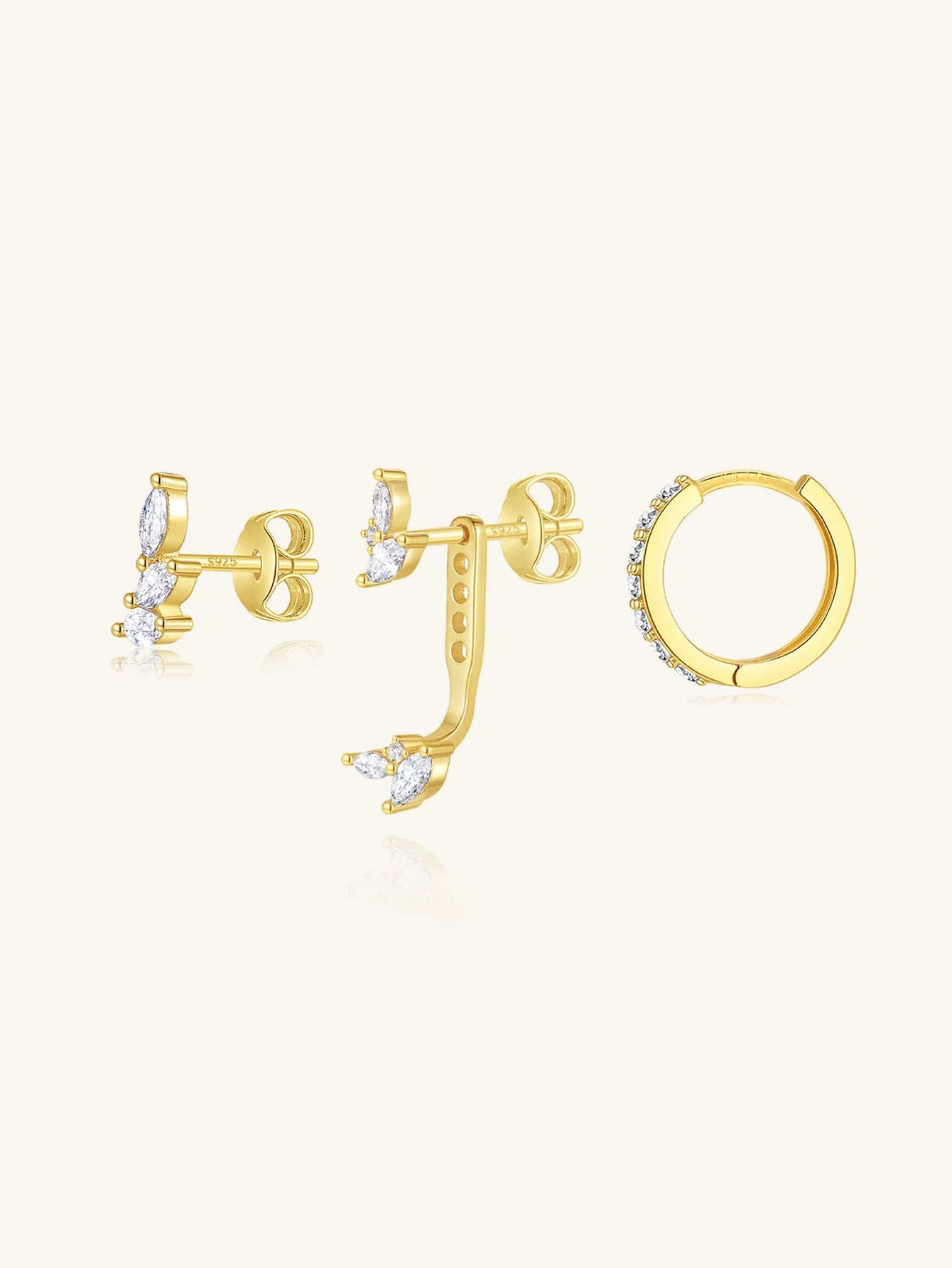 Three pairs of 18k gold-plated earrings with clear marquise-cut cubic zirconia stones, including studs and a hoop.