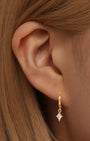 Kosiner 18k gold plated hypoallergenic hoop earring with quadrilateral cubic zirconia pendant on model.