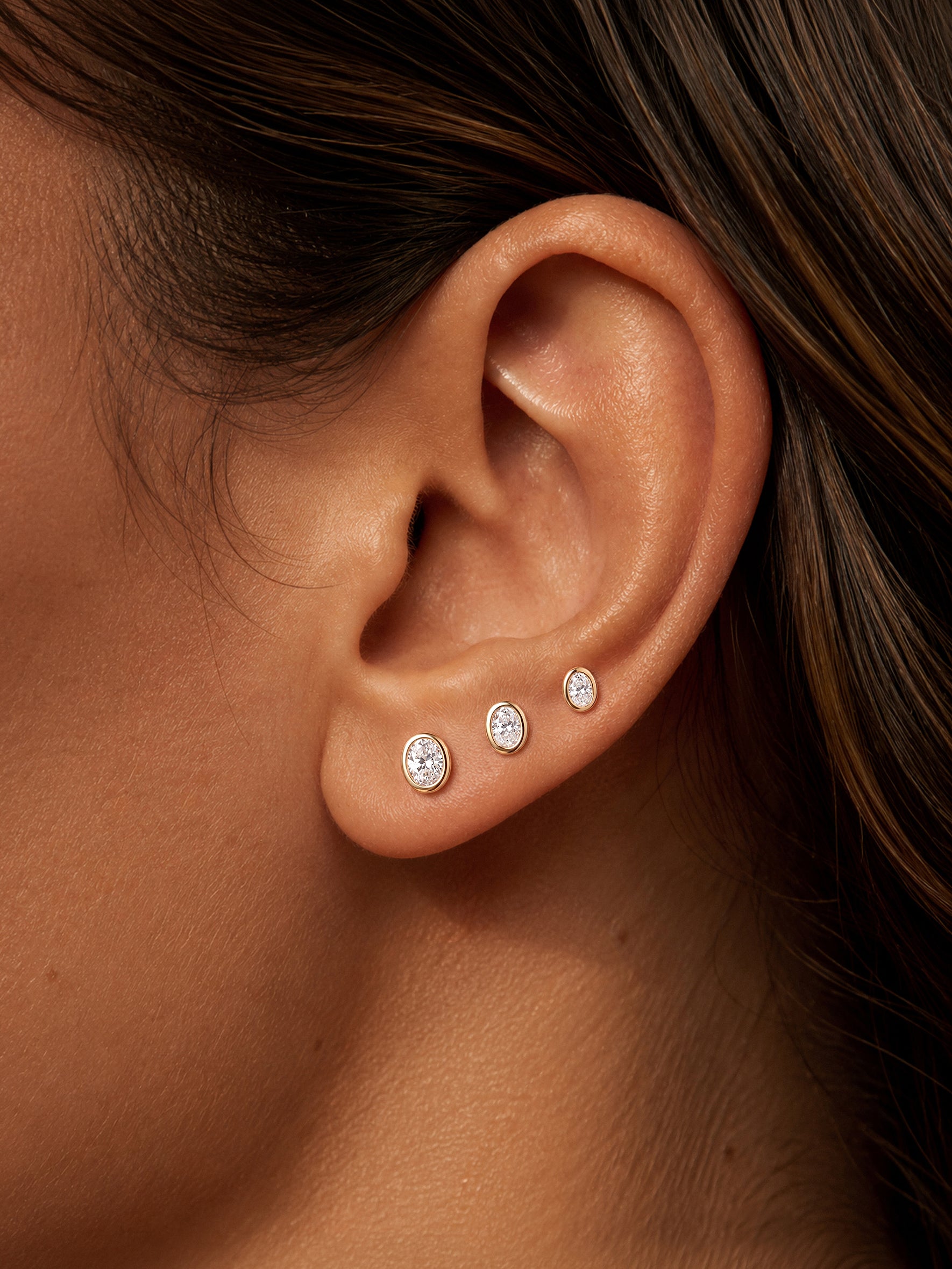 KOSINER oval lab-grown diamond flat back studs in 3mm, 3.5mm and 4mm sizes on ear