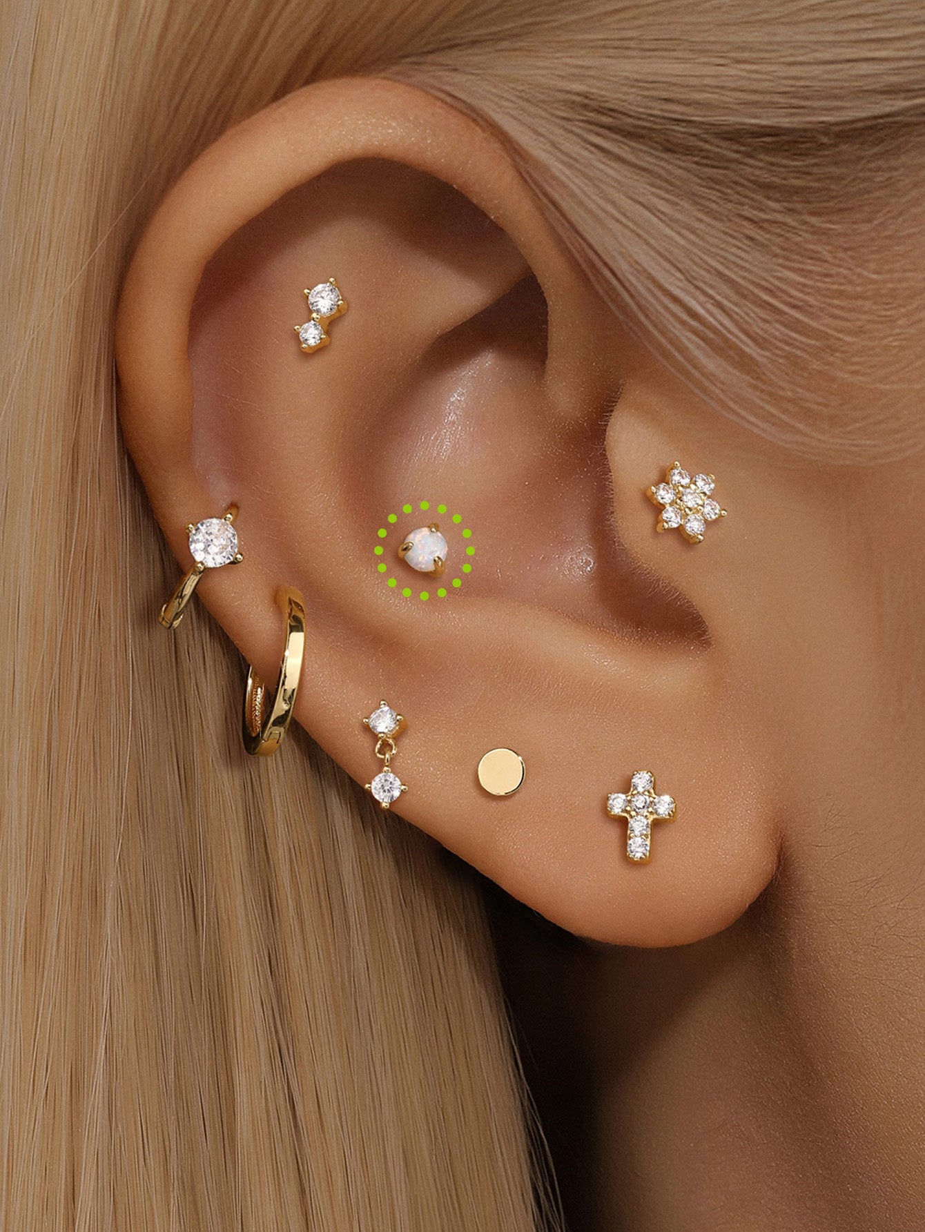 14K solid gold mini ear piercing stud with white opal, shown in ear stack. Hypoallergenic and tarnish-proof.