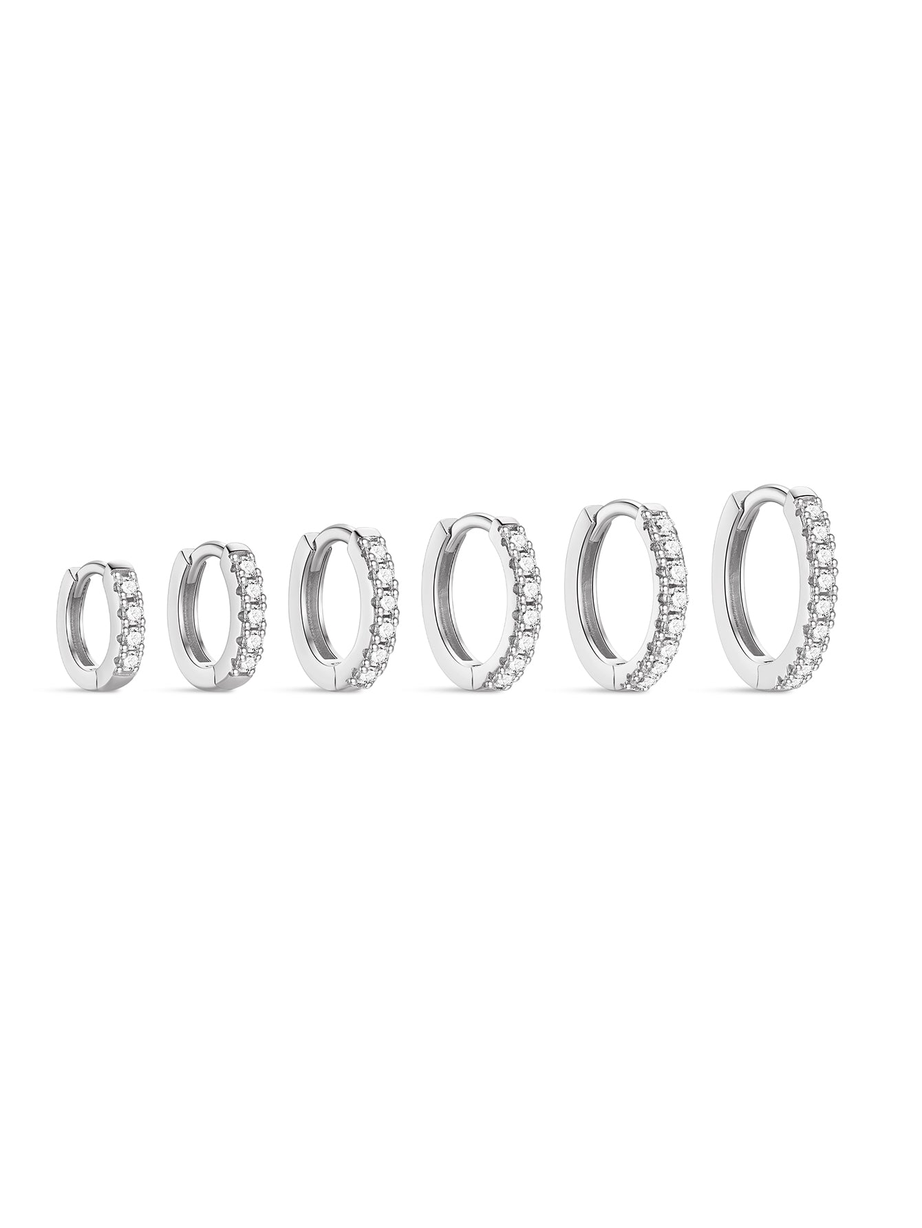Five silver huggie hoop earrings with cubic zirconia, showcasing size variations from 6mm to 14mm inner diameter.