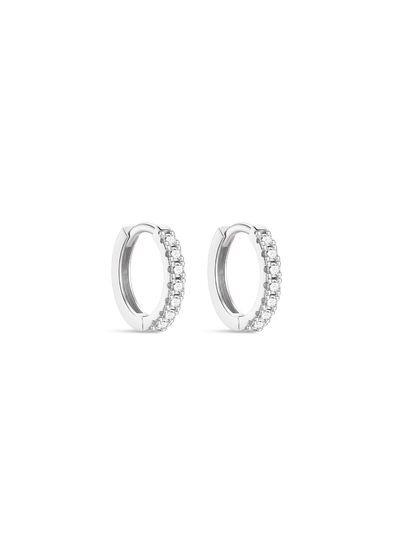 Pair of sterling silver dainty huggie hoop earrings with channel-set cubic zirconia stones on white background.