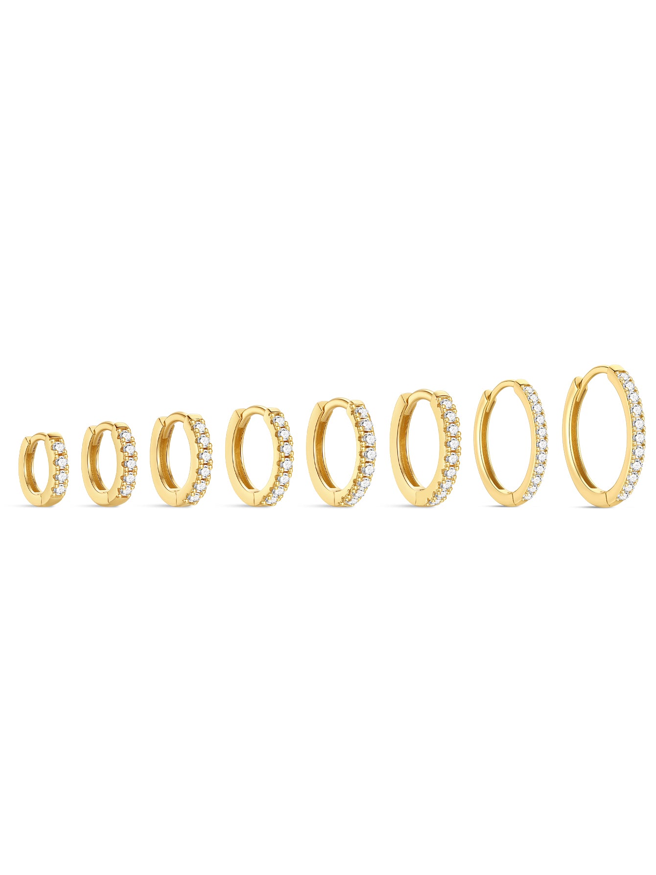 Seven gold huggie hoop earrings with cubic zirconia in ascending sizes, 6mm to 14mm inner diameter.