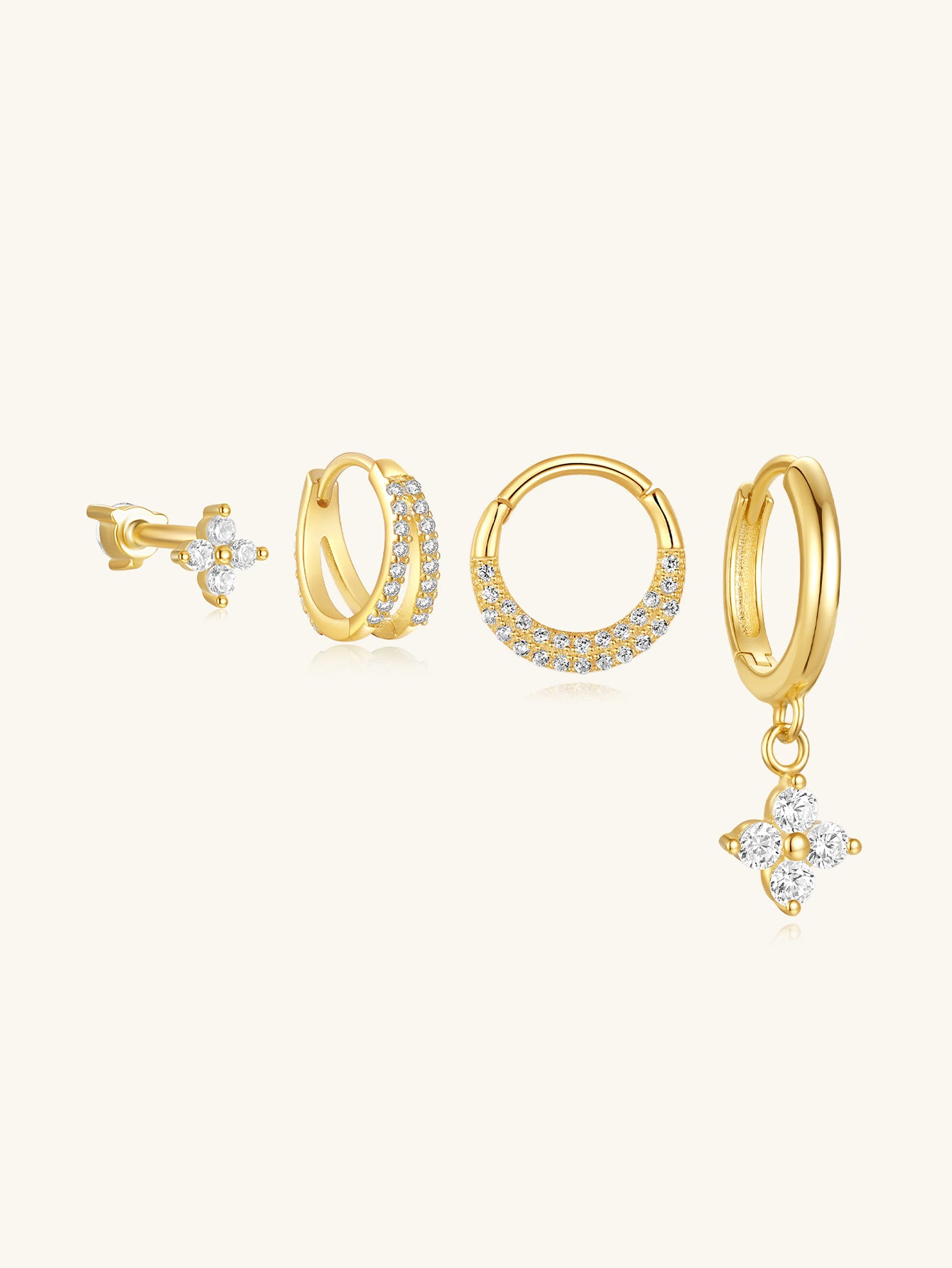 Four 18kt gold-plated sterling silver CZ earrings: stud, double hoop, segmented hoop, clover charm drop.