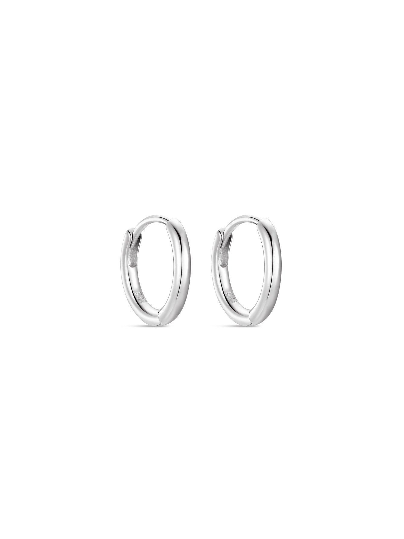 Pair of polished sterling silver huggie hoop earrings on white background, classic daily wear.