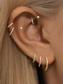 Gold titanium 16g cartilage hoop earrings with 5A CZ stones, worn on ear to show placement and sparkle.