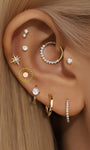 Ear styling featuring a 14K solid gold 3.5mm flat disc internally threaded labret stud and other gold piercings.