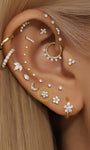 14K gold CZ ear piercings: stars, moons, flowers, crosses styled on ear.