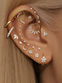 14K solid gold pave crescent moon ear piercing stud with clear stones on styled ear. Showcase of multiple piercings.