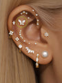 14K solid gold butterfly piercing stud with AAAAA cubic zirconia, internally threaded flatback labret on ear.
