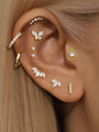 14K gold CZ ear piercings: butterfly, bar, marquise, round studs on ear.